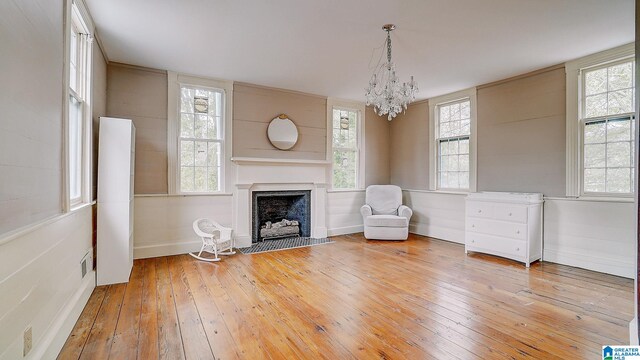 unfurnished room featuring hardwood / wood-style floors and a notable chandelier