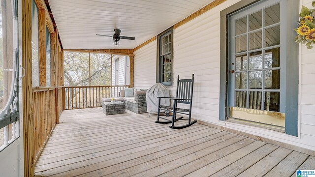 wooden deck with covered porch and ceiling fan