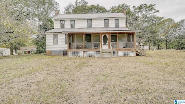 farmhouse-style home featuring central AC unit, a porch, and a front lawn