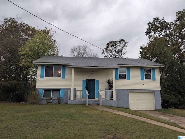 split foyer home with a front yard, covered porch, and a garage