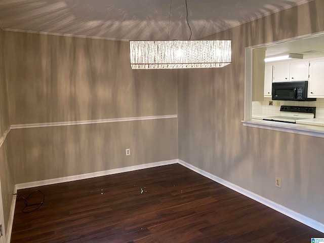 unfurnished dining area featuring wood-type flooring and an inviting chandelier