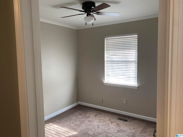 unfurnished room with ornamental molding, light carpet, and ceiling fan