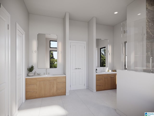 bathroom featuring vanity, a shower with door, and a healthy amount of sunlight