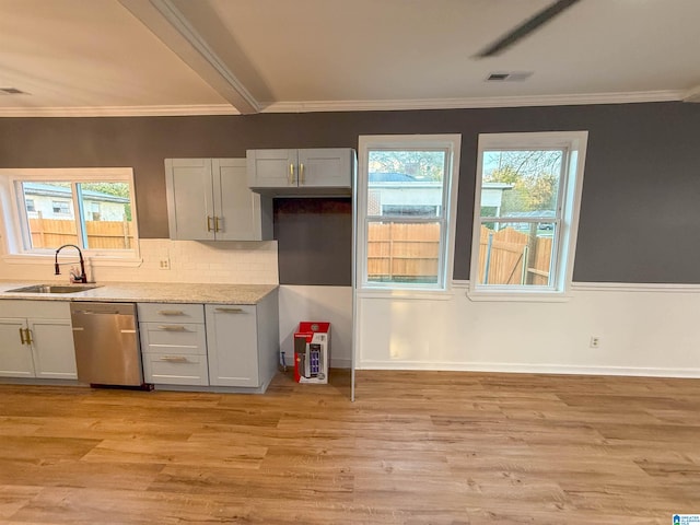 kitchen with ornamental molding, sink, stainless steel dishwasher, and light wood-type flooring