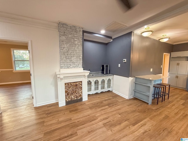 unfurnished living room featuring light hardwood / wood-style floors and ornamental molding