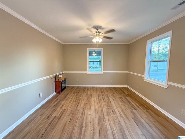 empty room with light wood-type flooring, ceiling fan, and crown molding