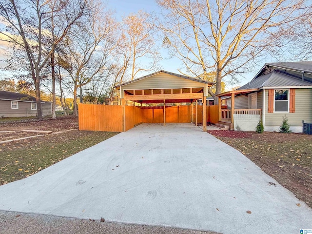 view of home's exterior with covered porch, a carport, and a lawn