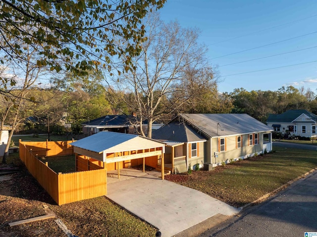 view of front facade with a carport and a front yard