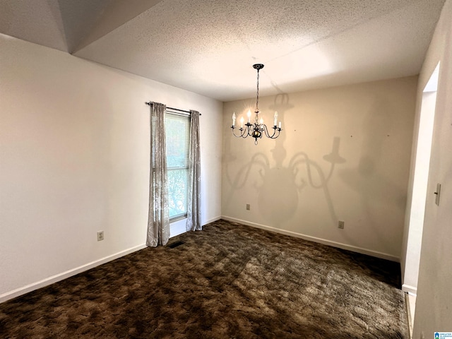 unfurnished dining area with a textured ceiling, an inviting chandelier, and dark carpet