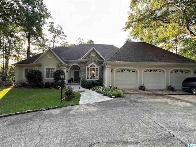 single story home featuring a garage and a front lawn