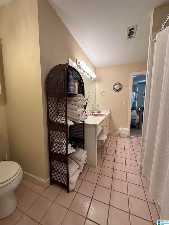 bathroom featuring vanity, tile patterned floors, and toilet