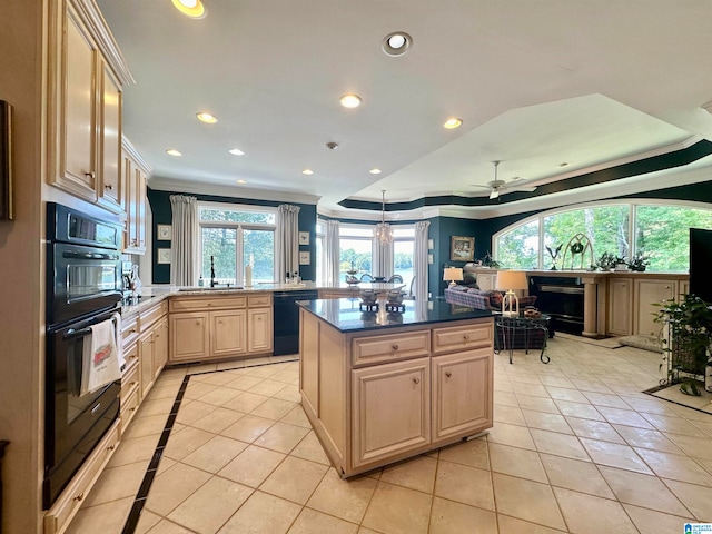 kitchen with light tile patterned floors, a wealth of natural light, sink, and black appliances