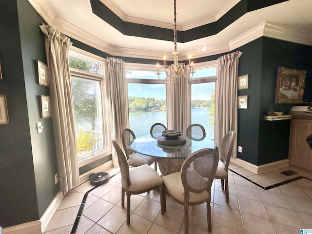 dining room with a wealth of natural light, a water view, and ornamental molding