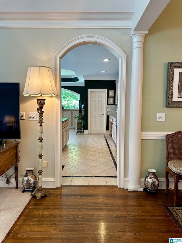 hall featuring wood-type flooring and ornamental molding