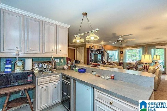 kitchen with kitchen peninsula, ornamental molding, ceiling fan, decorative light fixtures, and wine cooler