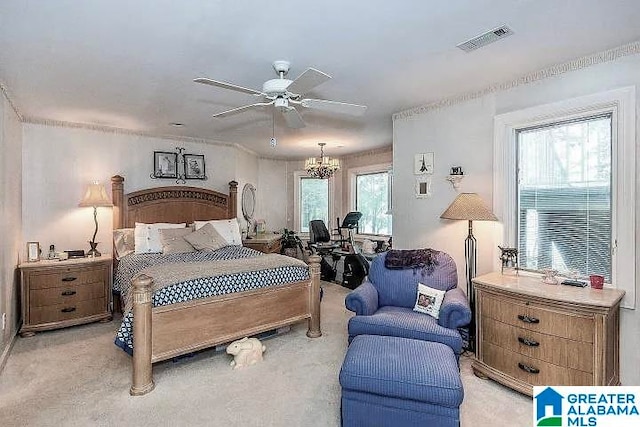 carpeted bedroom featuring ceiling fan with notable chandelier and multiple windows