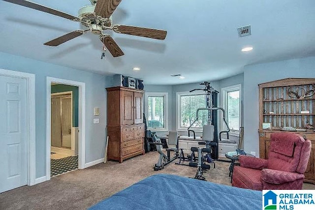 exercise room featuring light carpet and ceiling fan