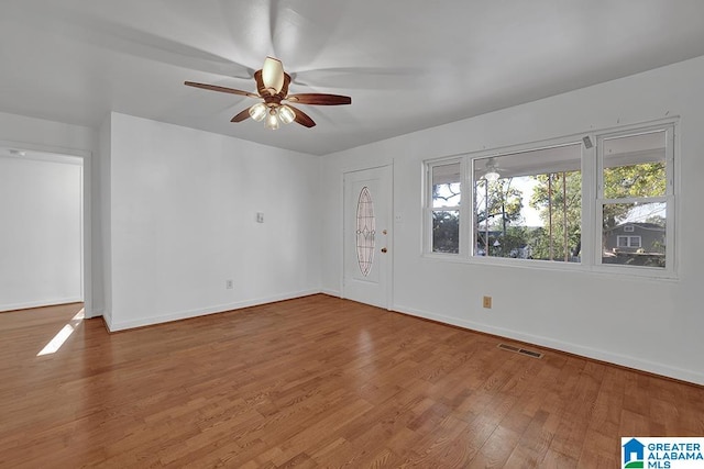 spare room with wood-type flooring and ceiling fan