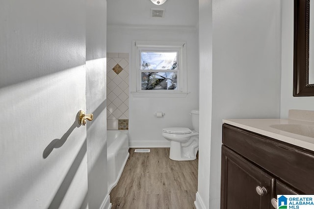 bathroom with crown molding, toilet, vanity, and hardwood / wood-style flooring