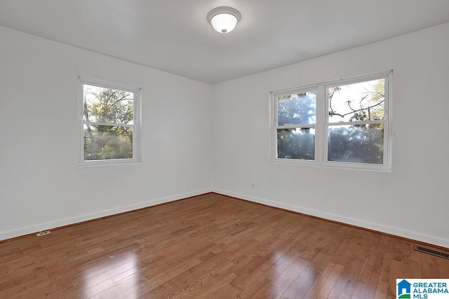 spare room with hardwood / wood-style flooring