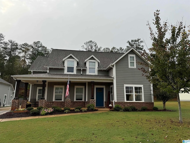 view of front of home with a porch and a front lawn