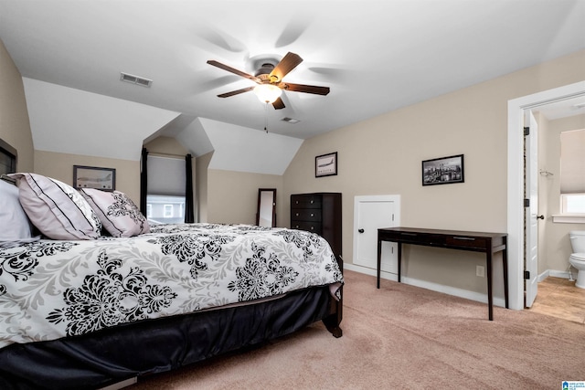 carpeted bedroom featuring ceiling fan, lofted ceiling, and connected bathroom