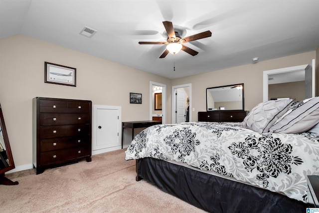 bedroom with connected bathroom, light colored carpet, ceiling fan, and lofted ceiling