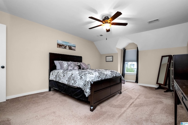 bedroom with light colored carpet, ceiling fan, and lofted ceiling