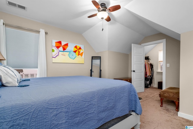 bedroom featuring light colored carpet, ceiling fan, a spacious closet, a closet, and lofted ceiling