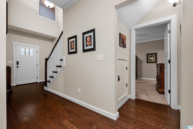 entrance foyer with crown molding and dark wood-type flooring