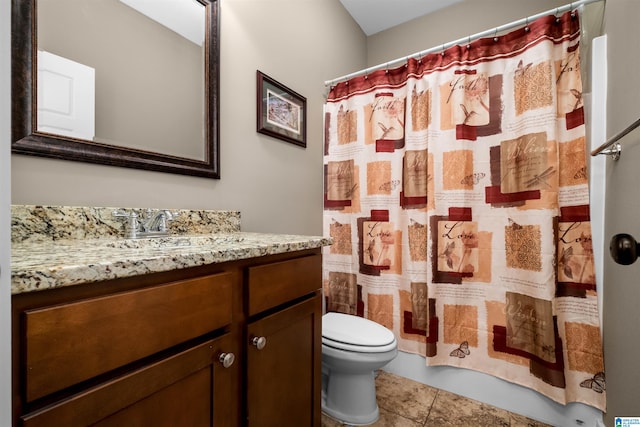 bathroom featuring toilet, vanity, tile patterned floors, and curtained shower