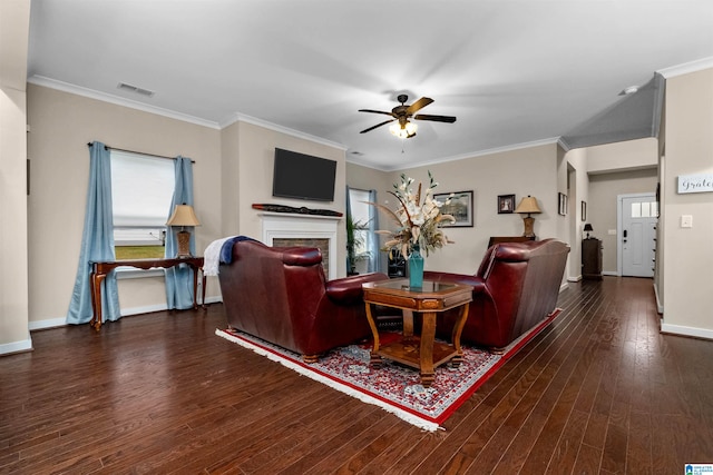 living room featuring crown molding, ceiling fan, and dark wood-type flooring