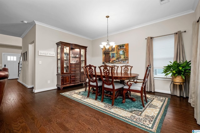 dining area with crown molding, dark wood-type flooring, and a chandelier