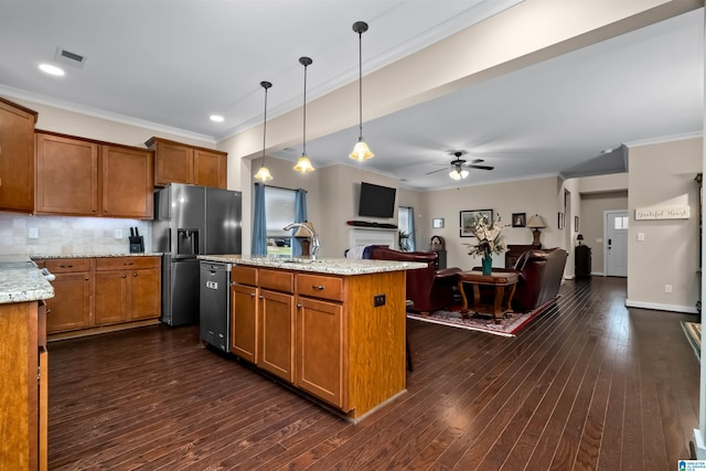 kitchen featuring a kitchen island with sink, hanging light fixtures, dark hardwood / wood-style floors, ceiling fan, and light stone countertops