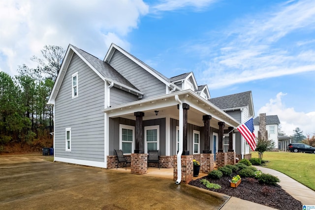 view of front of property with a porch and a front lawn