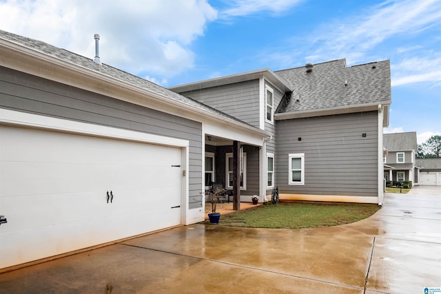 back of property featuring a garage