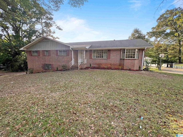ranch-style home with brick siding and a front yard
