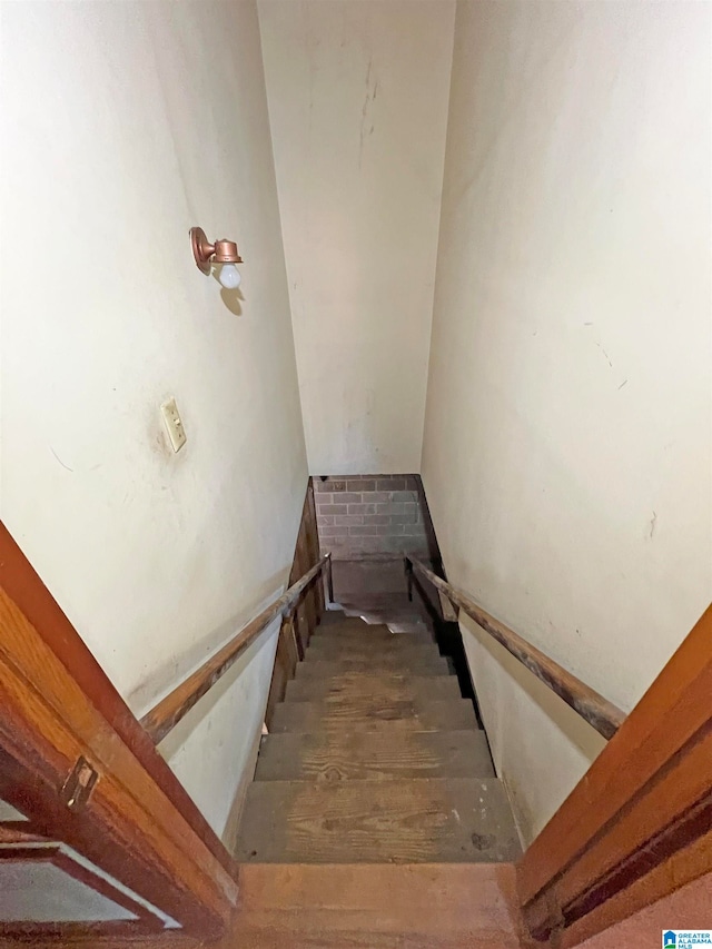 staircase with hardwood / wood-style flooring