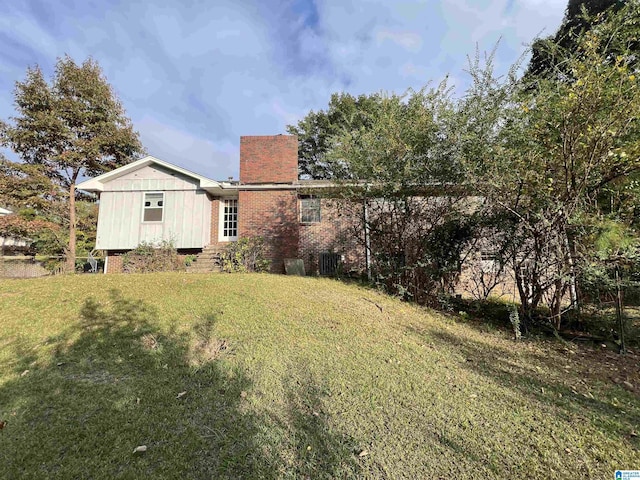 view of grassy yard with central AC