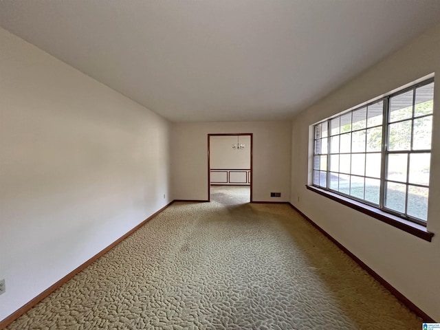 carpeted empty room featuring baseboards