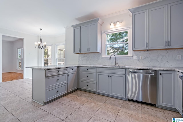 kitchen with sink, tasteful backsplash, ornamental molding, gray cabinets, and dishwasher