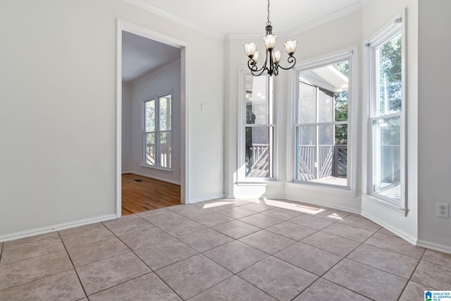 unfurnished dining area with a chandelier, light tile patterned floors, and crown molding