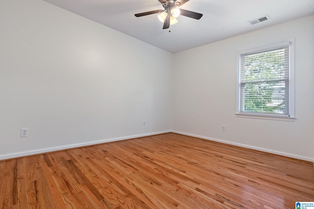 empty room with ceiling fan and light wood-type flooring