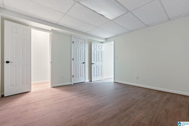 interior space featuring hardwood / wood-style flooring and a drop ceiling