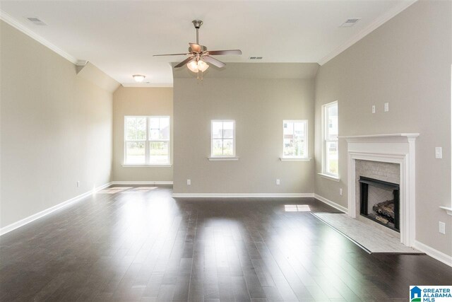 unfurnished living room featuring a brick fireplace, ceiling fan, dark hardwood / wood-style floors, and crown molding