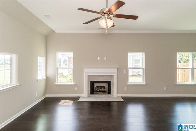 unfurnished living room with a wealth of natural light, dark hardwood / wood-style floors, and crown molding