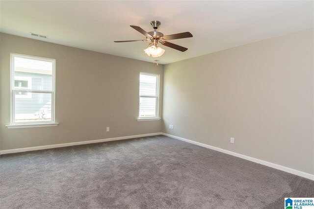 spare room featuring carpet floors and ceiling fan