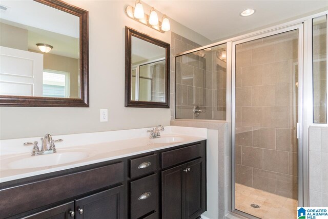 bathroom featuring walk in shower and vanity