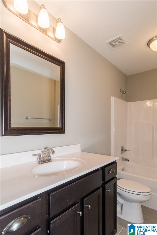 full bathroom with tile patterned floors, vanity, toilet, and shower / bathtub combination