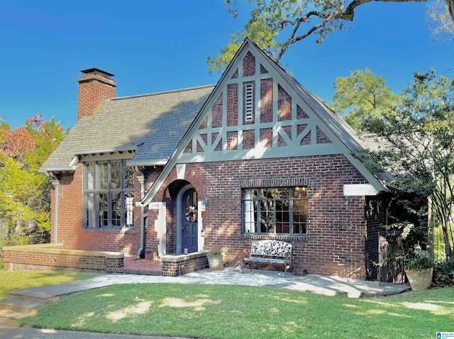 tudor home featuring a front yard